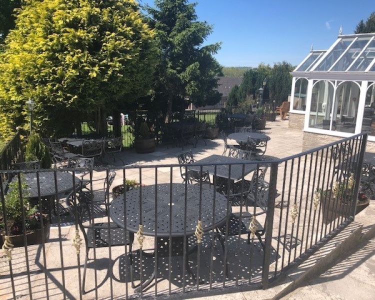 terrace area outside the inn with chairs and tables