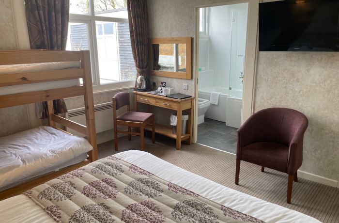 Standard family room with bunk beds and view into bathroom