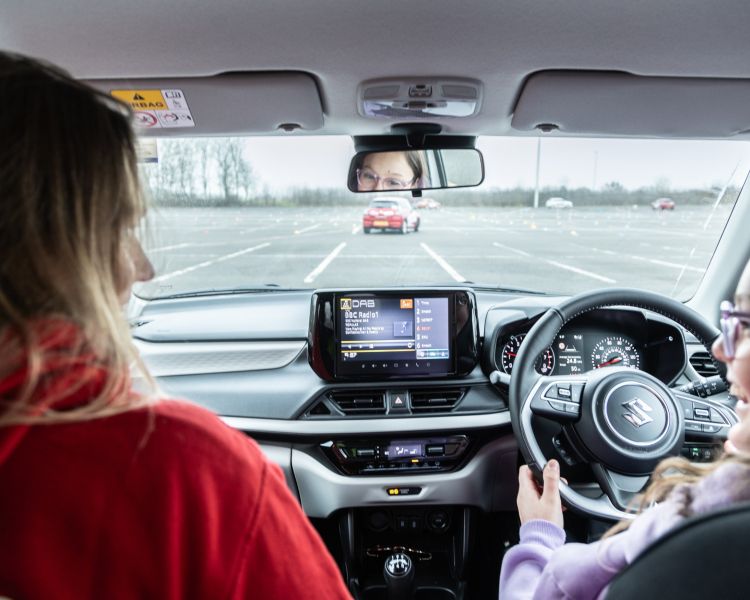 A young driver and instructor in a car