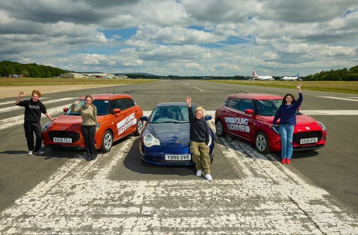 A group of young drivers in front of 3 cars