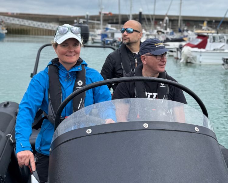 woman at helm of powerboat on a powerboat two day training course in brighton