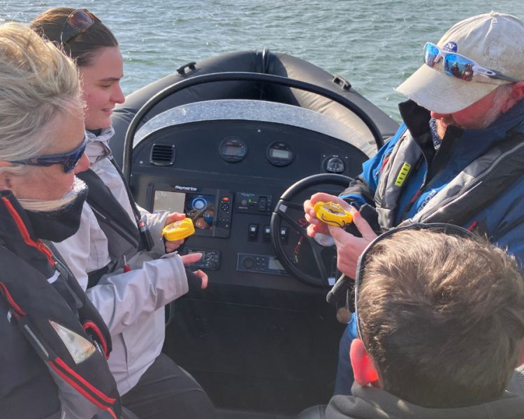 people being shown controls on a powerboat on a powerboat two day training course in brighton