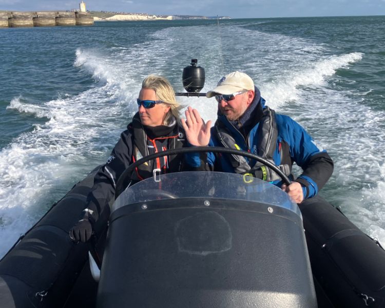 woman steering powerboat on a powerboat two day training course in brighton