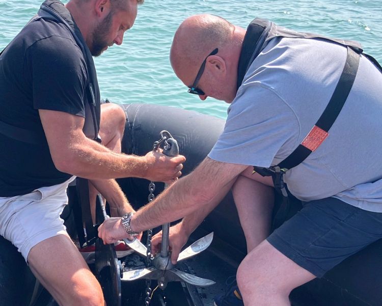 two men being shown the anchor on a powerboat two day training course in brighton