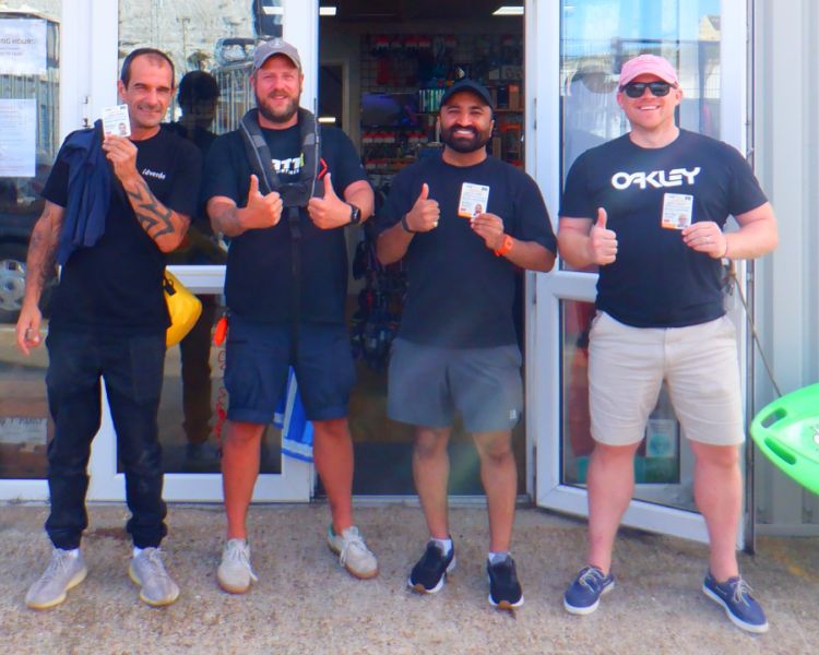 group of men giving thumbs up after having completed a two day powerboat training course in brighton
