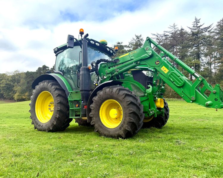 a modern green tractor in a field seen on a tractor driving experience