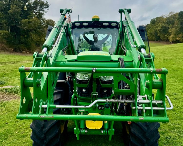 a rear view of a modern green tractor seen on a tractor driving experience