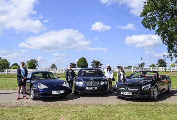 three young drivers stood by exclusive cars