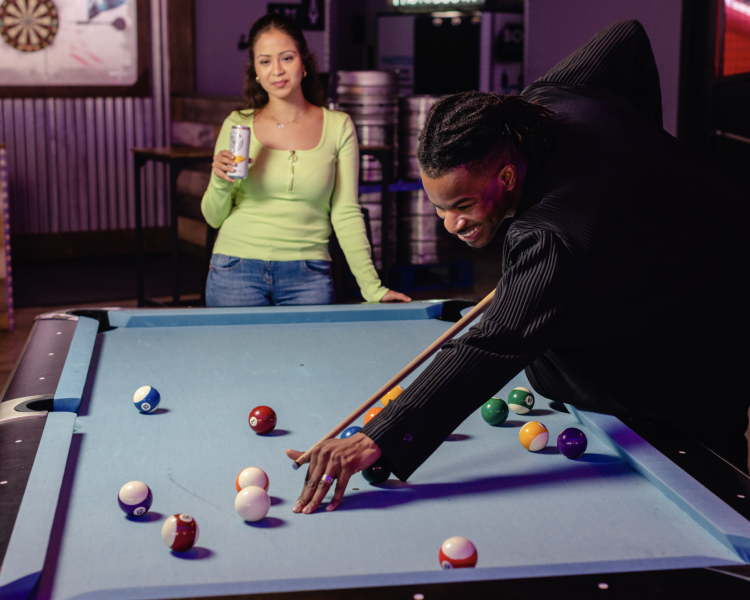 two people playing pool at boom battle bar