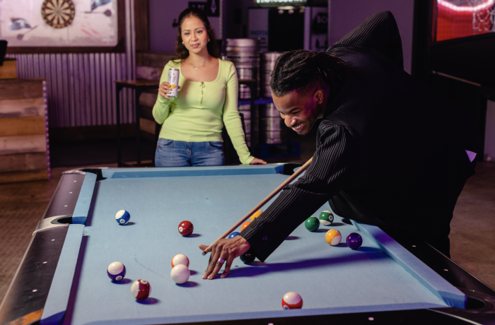 two people playing pool at boom battle bar