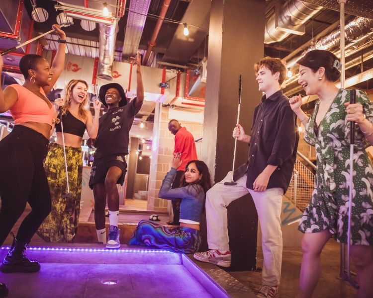 group playing crazy golf at a boom battle bar