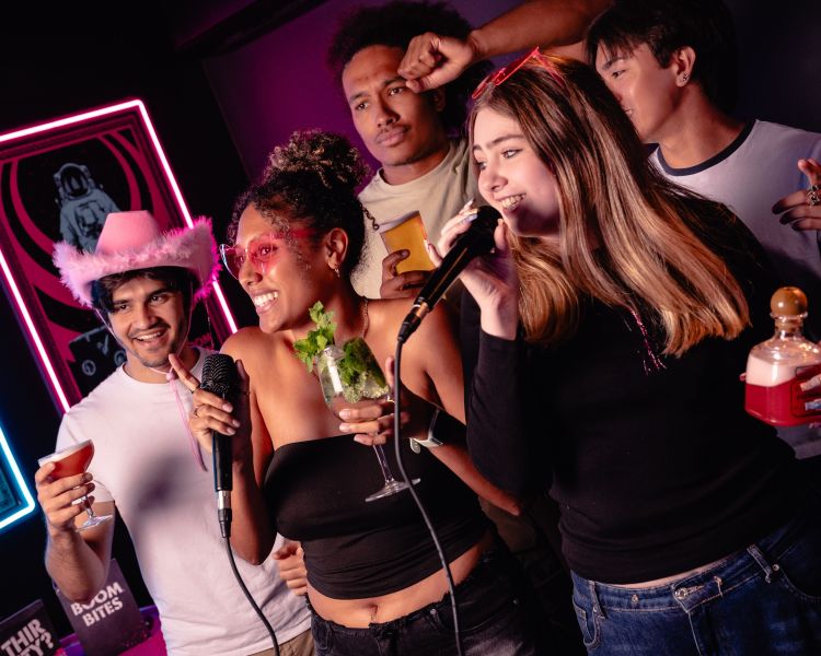 young people singing karaoke at a boom battle bar