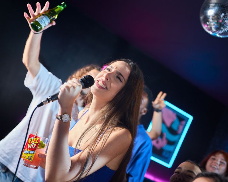 girl singing karaoke at a boom battle bar