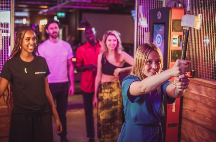 friends doing axe throwing at a boom battle bar