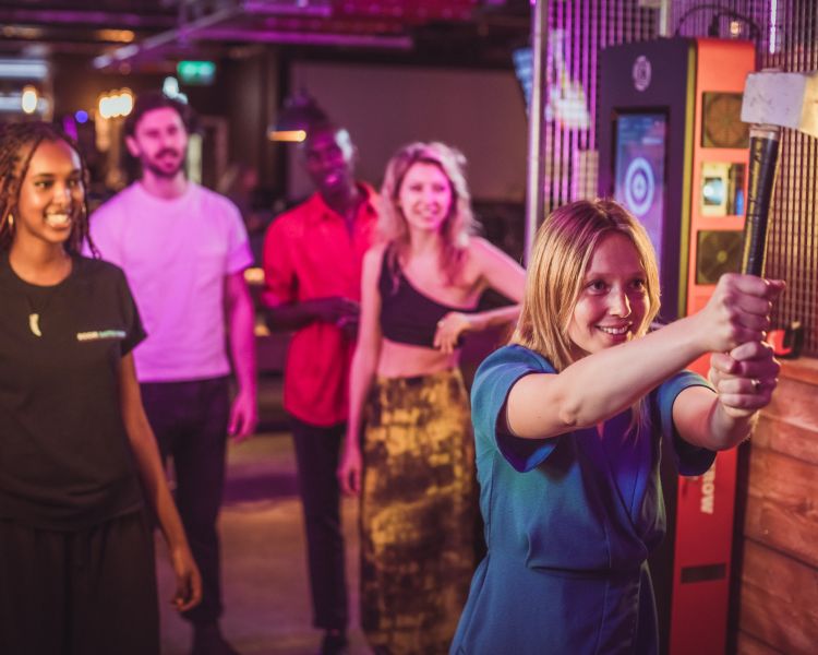 friends doing axe throwing at a boom battle bar
