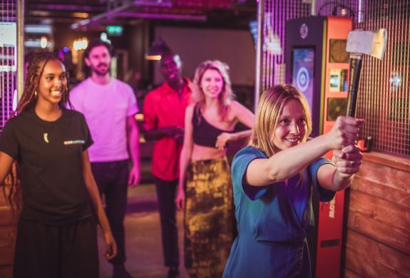 friends doing axe throwing at a boom battle bar
