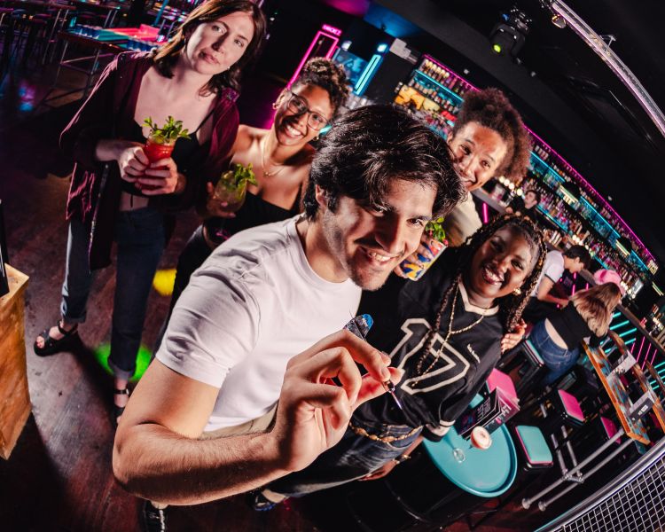 friends playing augmented reality darts at a boom battle bar