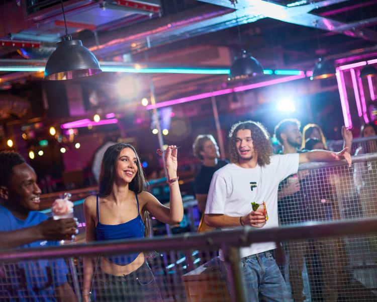 woman playing darts at a boom battle bar