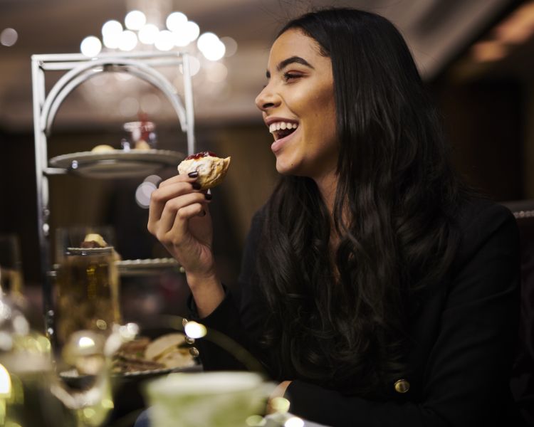 woman having afternoon tea at oulton hall hotel in yorkshire