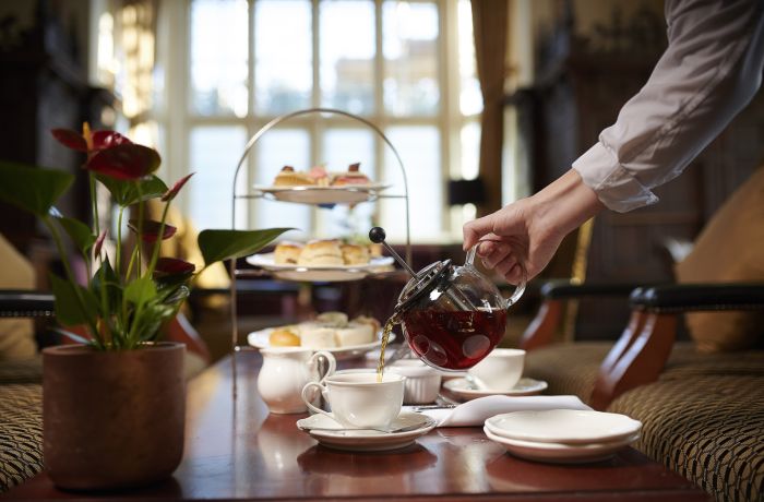 afternoon tea at crewe hall with tea being poured into teacup