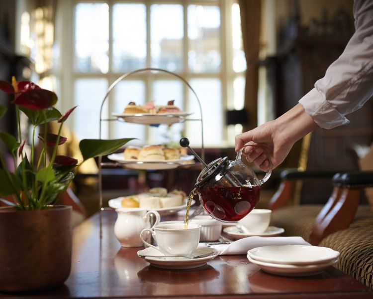 afternoon tea at crewe hall with tea being poured into teacup