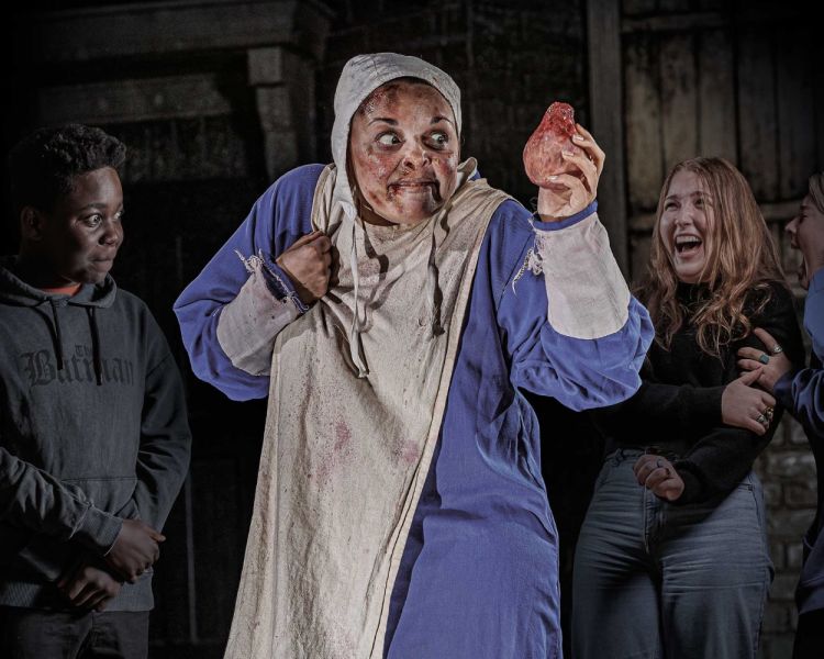 Plague Dr with guests at london dungeon