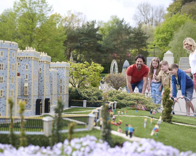 people looking at miniature village at legoland