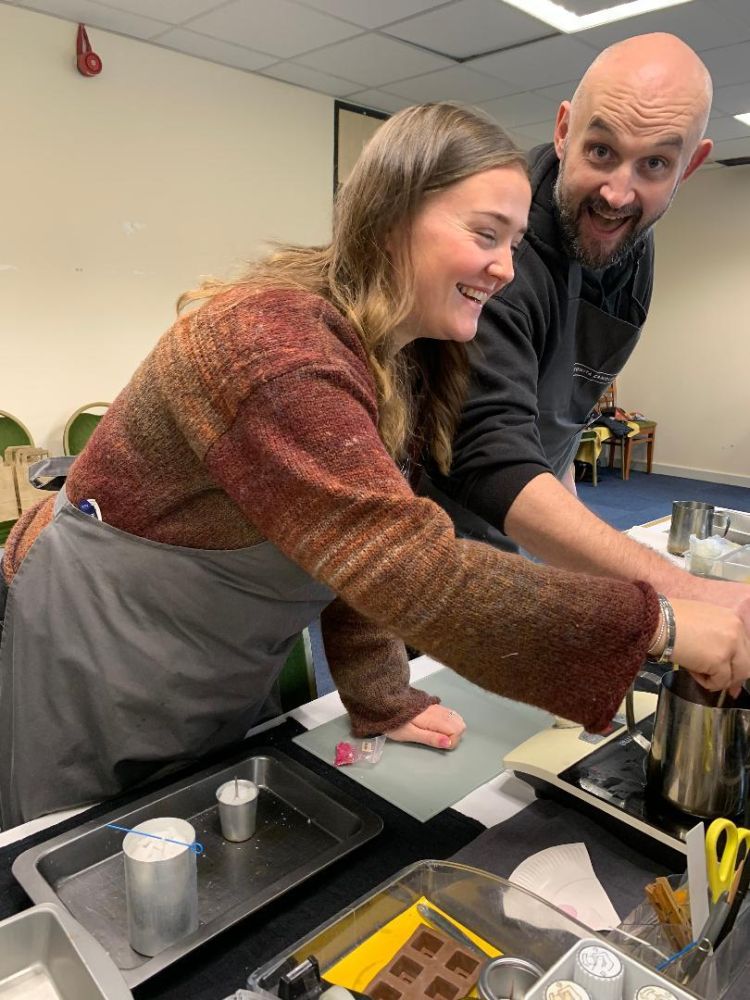 People laughing at candle making workshop