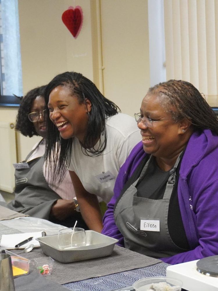 Ladies laughing at candle making workshop