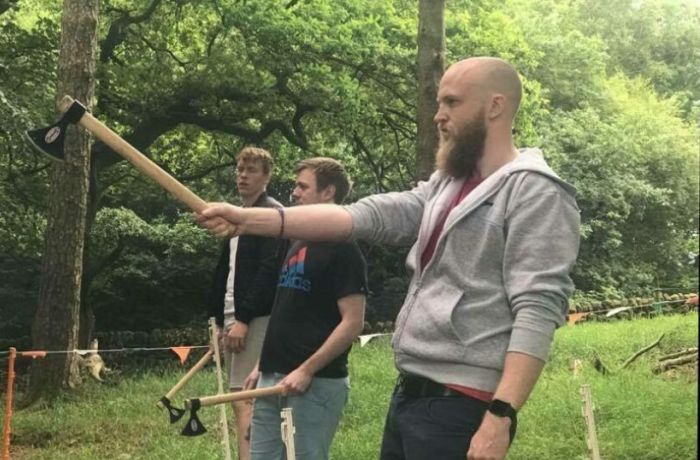 man preparing to throw an axe at the target on an axe throwing experience day