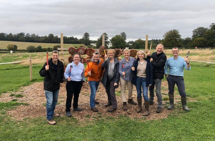 Group of people posing with axes on an axe throwing experience
