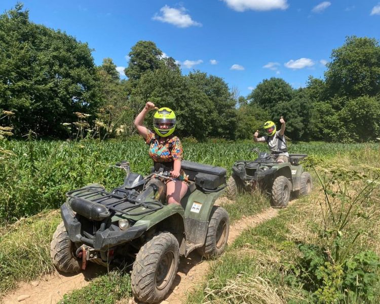 two people on quad bikes in sunshine