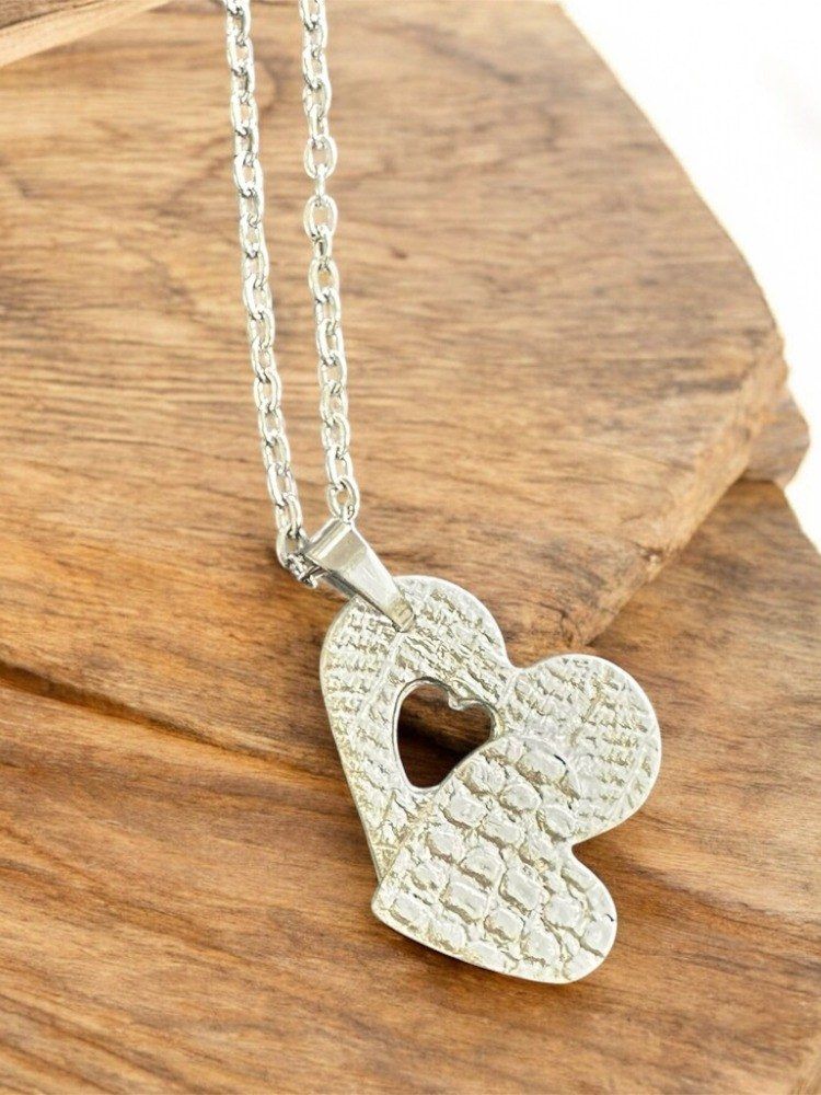 Heartshaped necklace made from silver clay