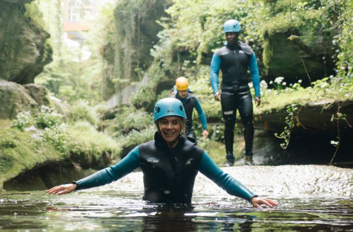 Lady smiling in water while gorge walking