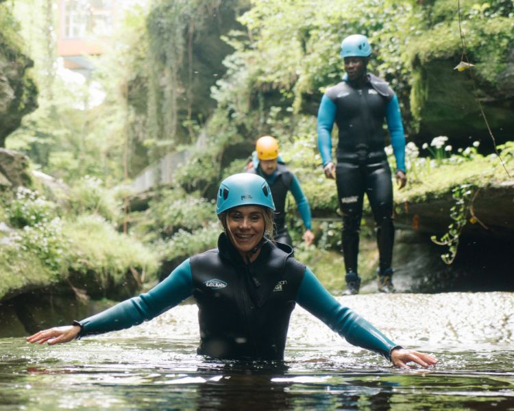 Lady smiling in water while gorge walking