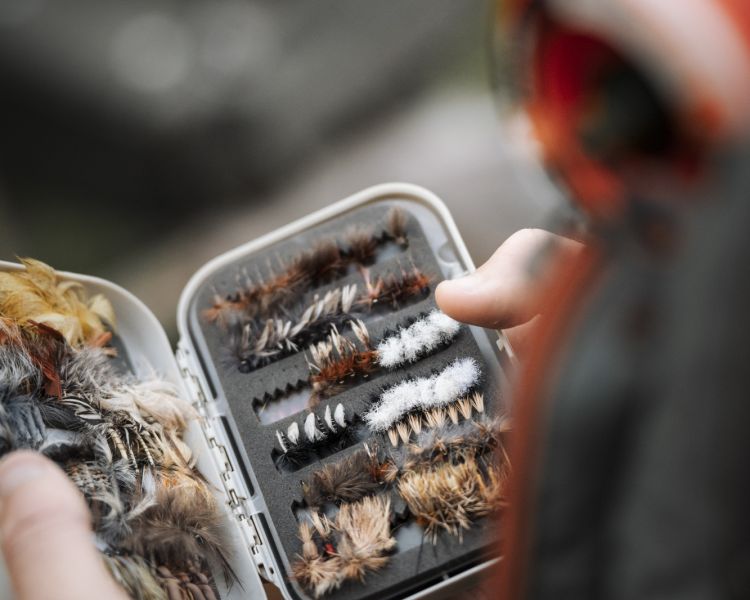 man opening box of fishing equipment
