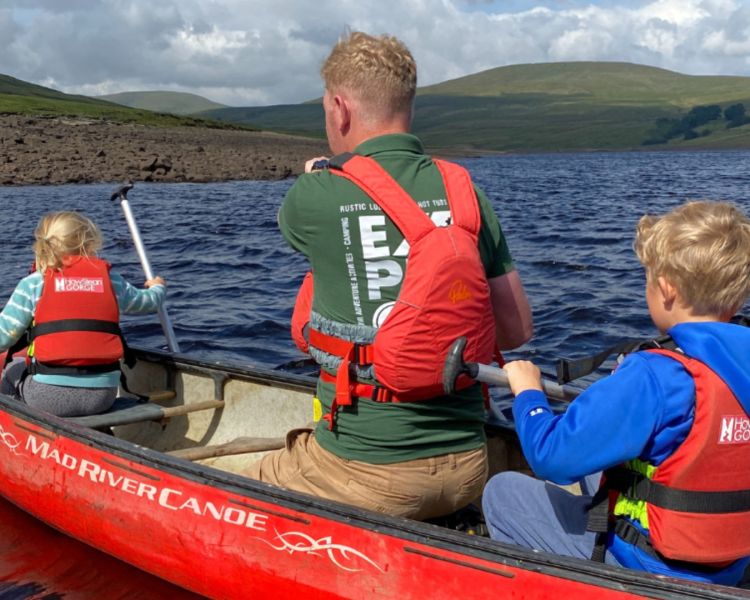 Father and children canoeing