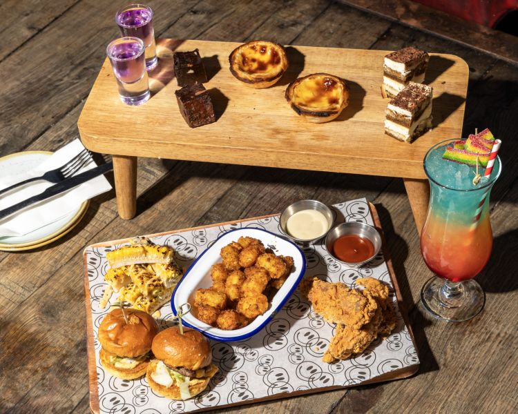 afternoon tea spread with a cocktail at revolution bars