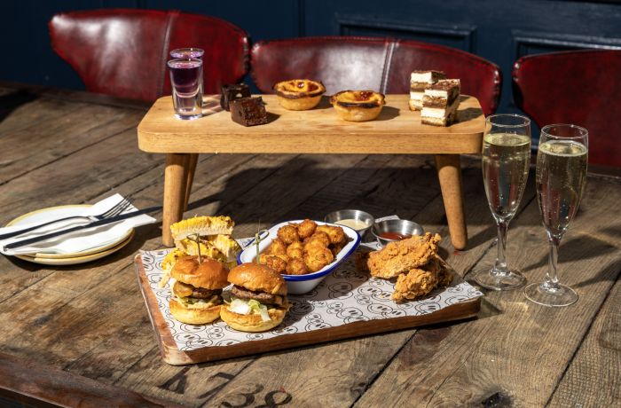 revolution bars afternoon tea spread with glasses of prosecco