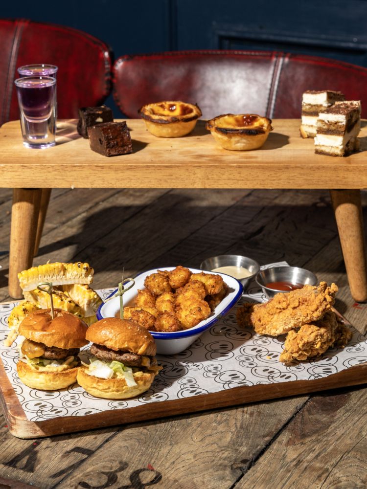 revolution bars afternoon tea spread with glasses of prosecco