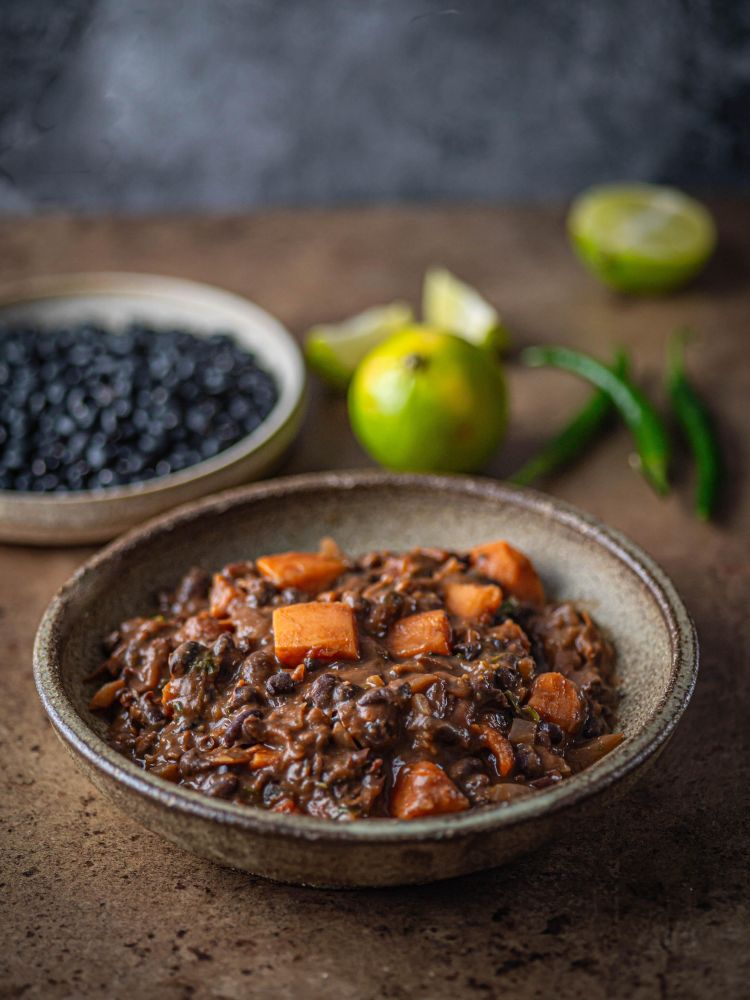 dish of food with vegetables in background