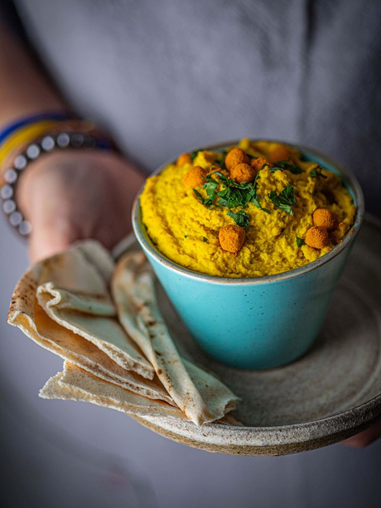 person holding bowl of food