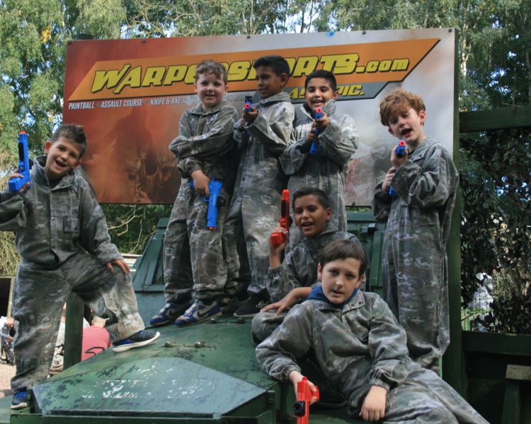 group of boys posing for photo on a gel ball experience
