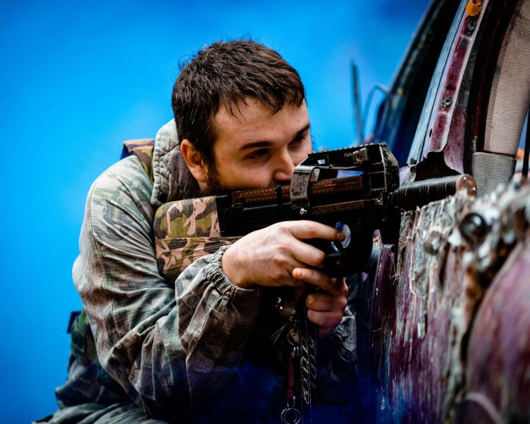man on outdoor laser combat experience in woodland
