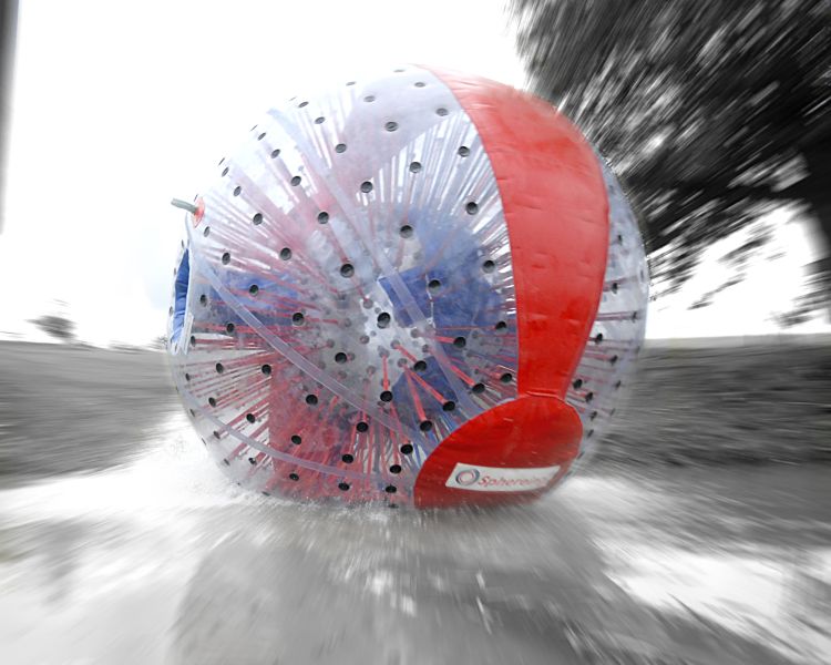 an aqua sphere rolling down the hill as part of an aqua sphereing experience day