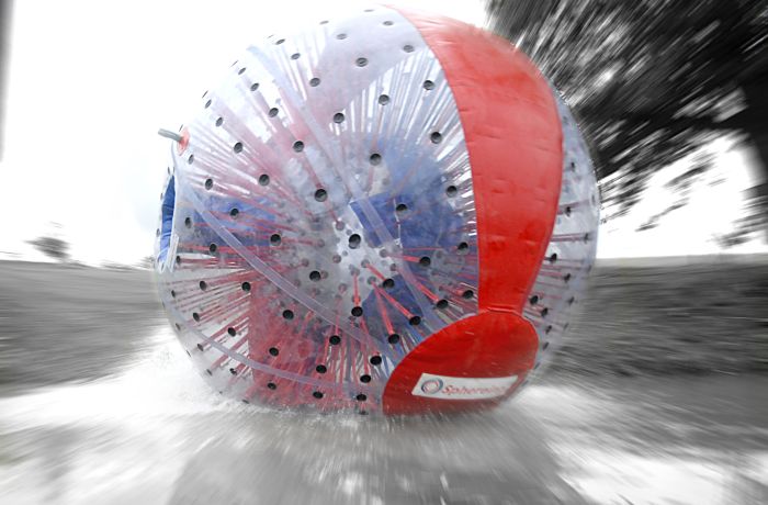 an aqua sphere rolling down the hill as part of an aqua sphereing experience day