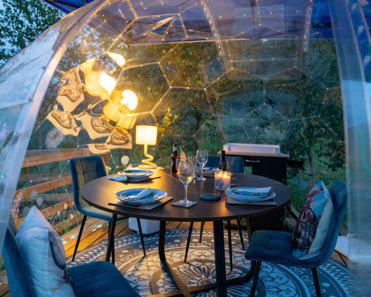A cosy dining geodome at dusk