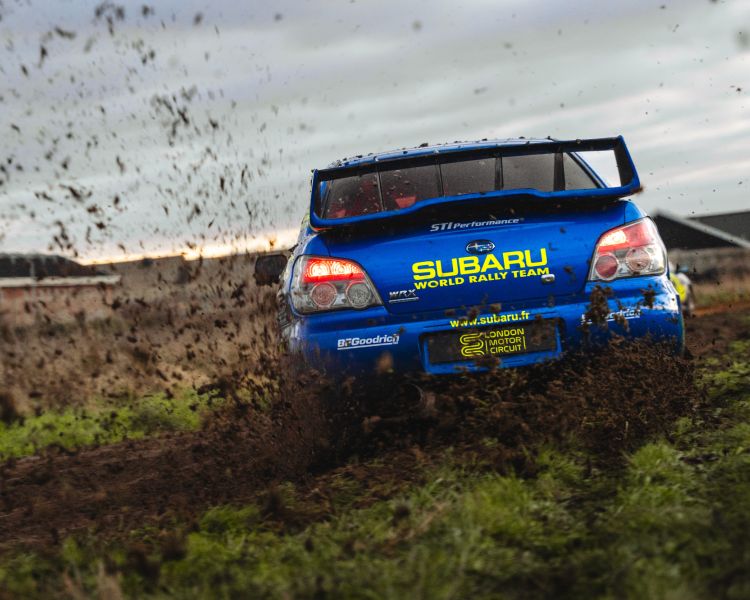 rear view of a subaru impreza on a dirt track for a rally driving experience day