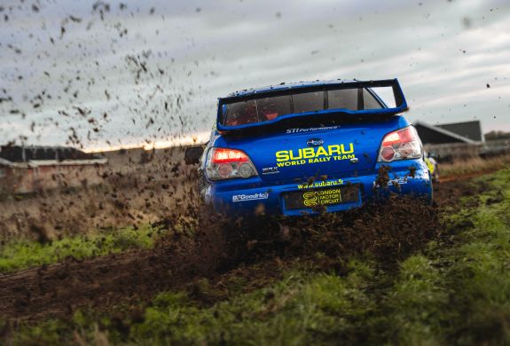 rear view of a subaru impreza on a dirt track for a rally driving experience day