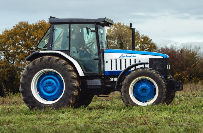a lamborghini tractor being driven in a field on a tractor driving experience